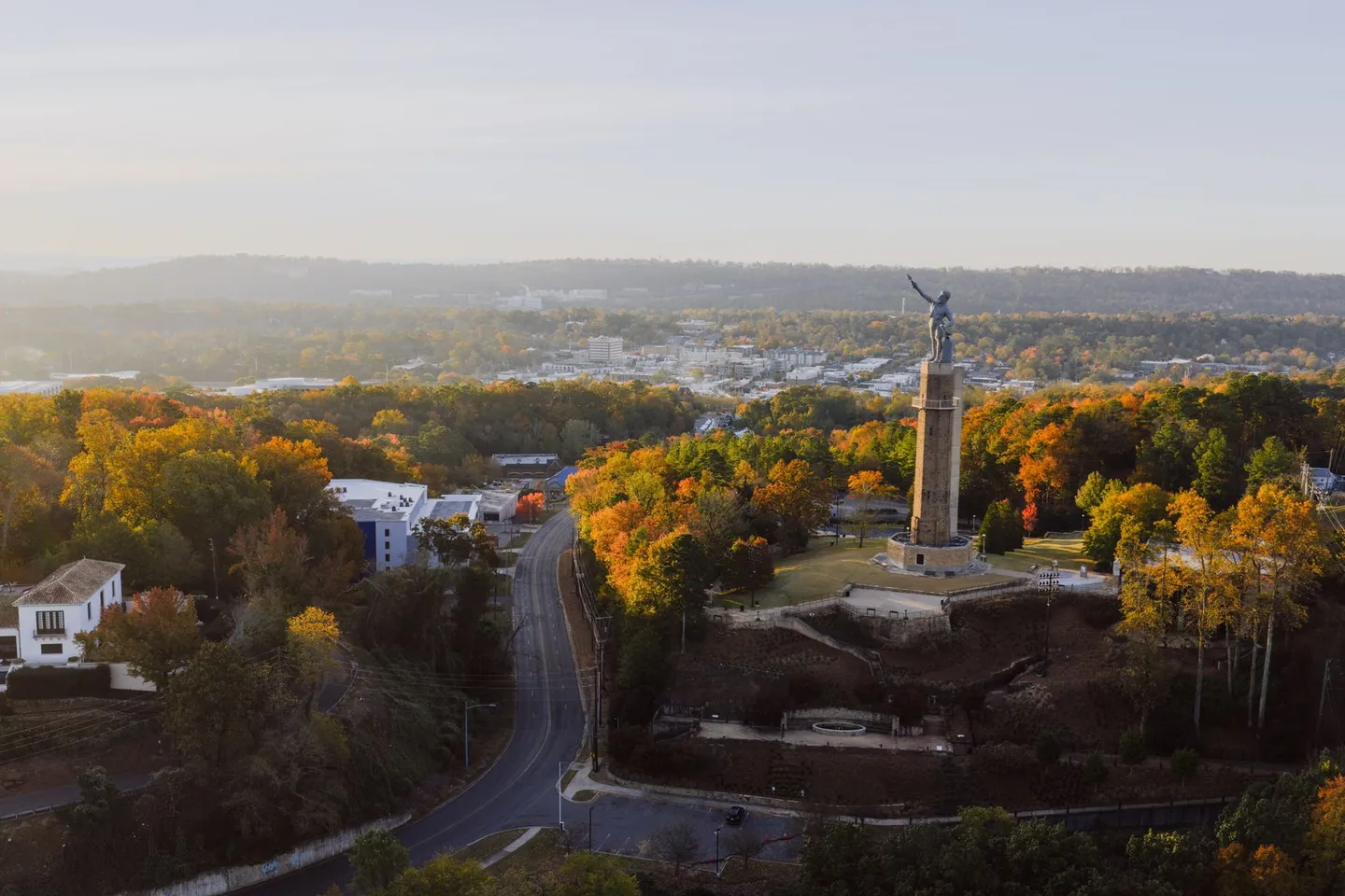 Aerial view of the Vulcan statue and autumn trees in Vulcan Park above Birmingham, Alabama.