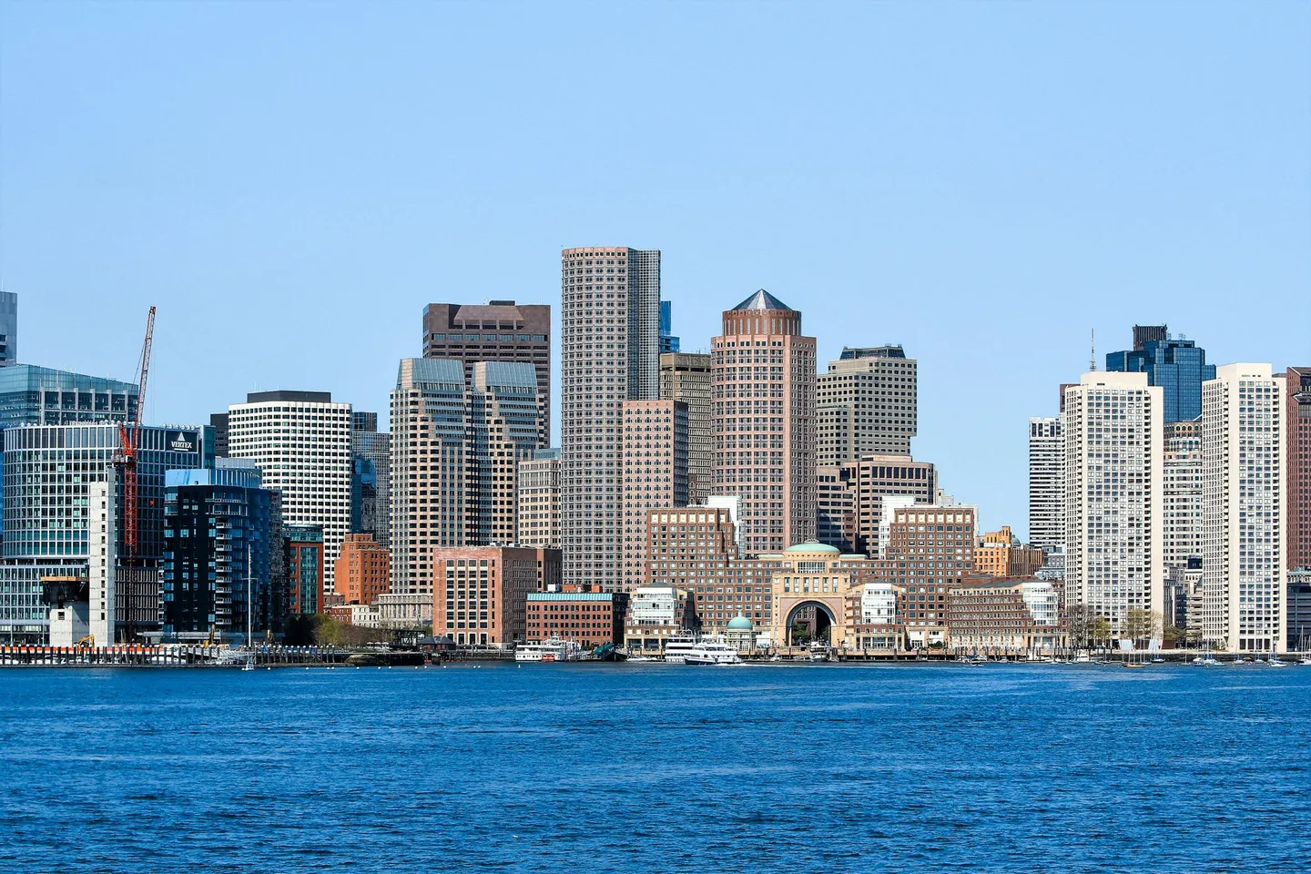 The Boston skyline rises above the harbor waterfront in Massachusetts.