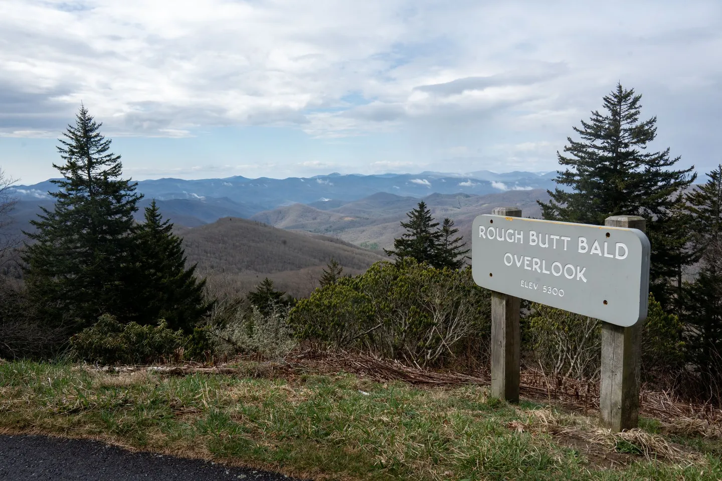 Blue Ridge Mountains stretch beyond the Rough Butt Bald overlook along the Blue Ridge Parkway in North Carolina.