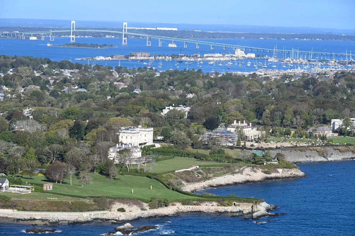 Newport mansions and the shoreline on Narragansett Bay, with the Newport Bridge beyond, in Rhode Island.